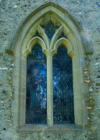 More recent stained glass window at the base of the tower