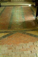 Brick flooring in the nave, joining the tiles of the chancel, with "not a right angle in the place".